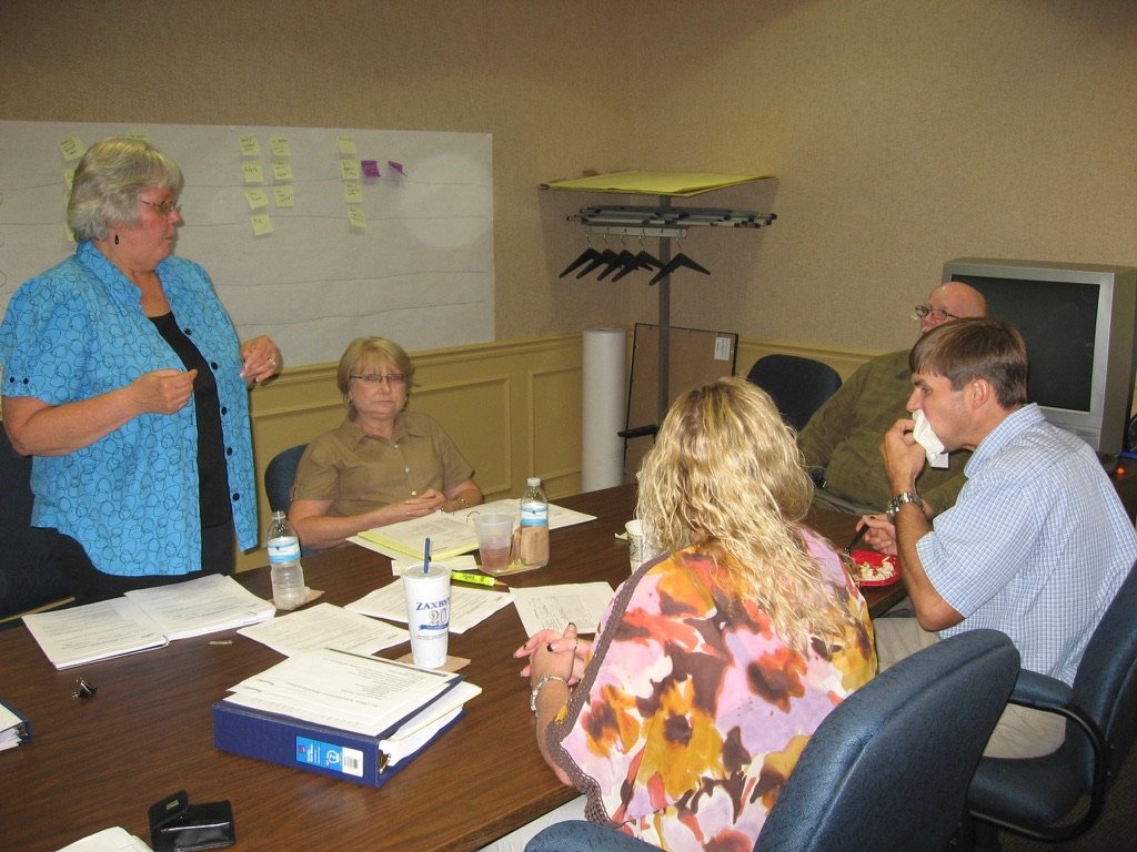 A team member standing to lead the discussion in a working session