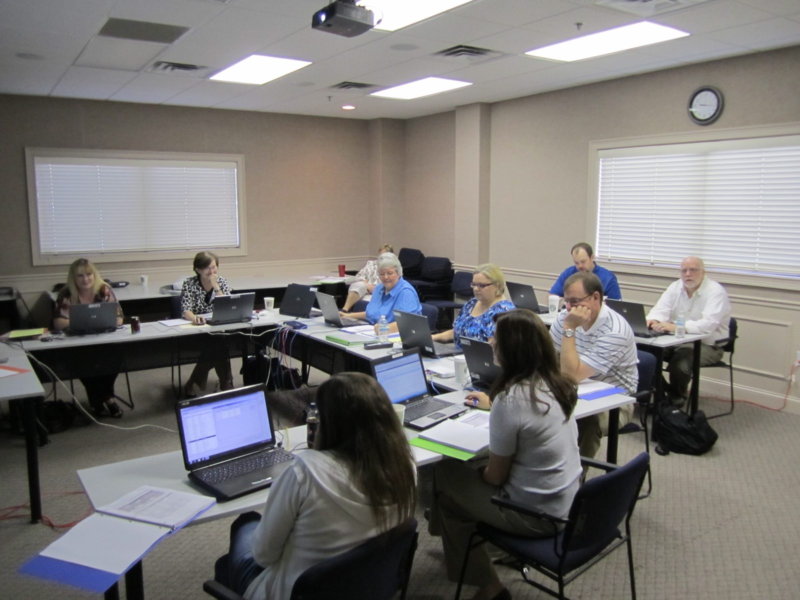 A systems training session, the trainer presenting the application on a projector